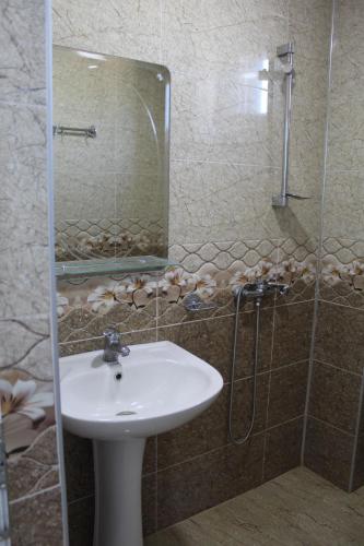 a bathroom with a sink and a glass shower at Hotel Georgia in Gonio