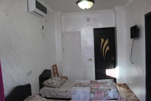 a room with a bed and a table and a door at Hotel Georgia in Gonio