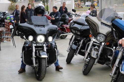 a person sitting on a motorcycle with a group of people at WR Confort Hotel Campo Grande in Campo Grande