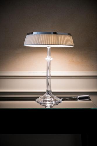 a clear glass lamp sitting on top of a table at Hotel Rua Frati 48 in San Francesco in Modena