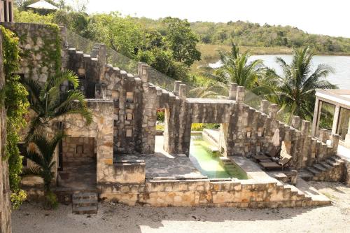 an old stone building with a swimming pool at Coqui Coqui Papholchac Coba Residence & Spa in Cobá