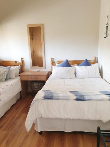 a bedroom with two large beds and a mirror at Cabana Del Mar 69 in Amanzimtoti