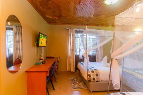a bedroom with a bed and a desk and a desk at Zarita Boutique Hotel in Nairobi