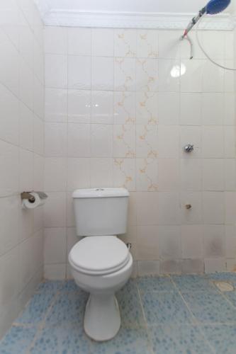 a bathroom with a white toilet and a shower at Zarita Boutique Hotel in Nairobi