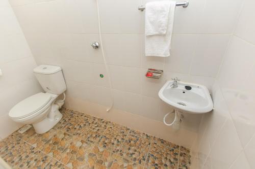 a bathroom with a toilet and a sink at Zarita Boutique Hotel in Nairobi