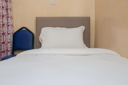 a bed with a pillow on top of it at Zarita Boutique Hotel in Nairobi