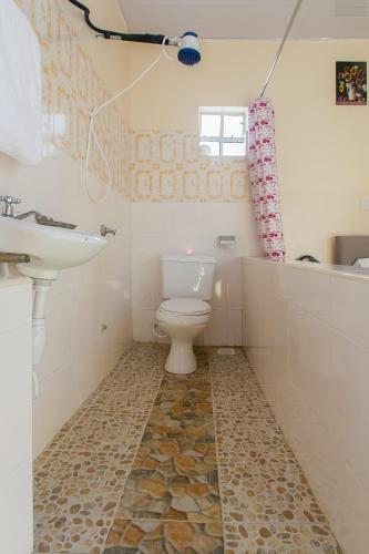 a bathroom with a toilet and a sink at Zarita Boutique Hotel in Nairobi