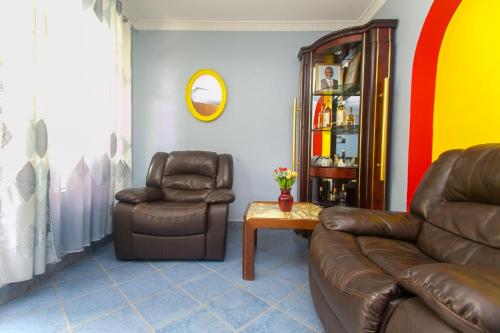 a living room with a couch and two chairs at Zarita Boutique Hotel in Nairobi