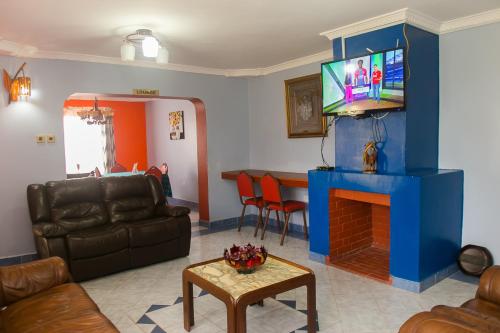 a living room with a couch and a fireplace at Zarita Boutique Hotel in Nairobi