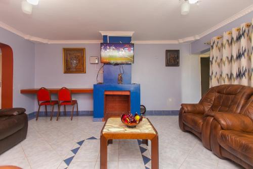 a living room with a couch and a fireplace at Zarita Boutique Hotel in Nairobi
