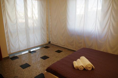 a bedroom with a bed with two towels on it at Business Home Piazza Cesare Battisti B&B Residence in Foggia