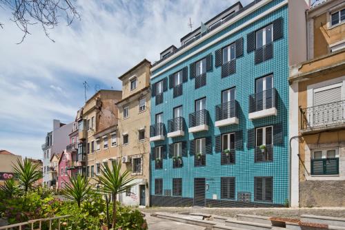 a blue building in the middle of a street at BmyGuest Bruno’s 36 Apartments in Lisbon