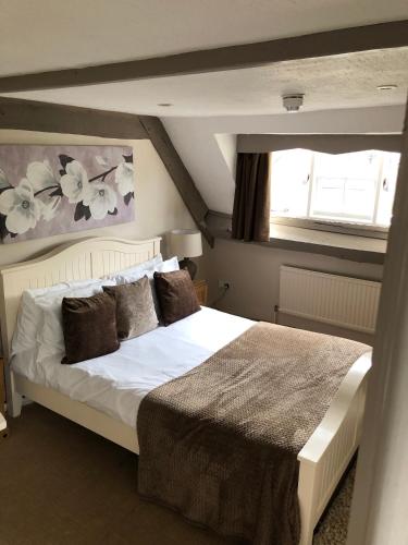 a bedroom with a large white bed in a room at The George at Nunney in Frome
