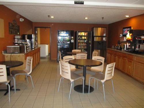 a restaurant with two tables and chairs and a counter at Heritage Inn Express in Marysville