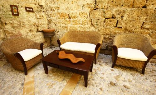 two chairs and a coffee table in a room at Khalisah in Palermo