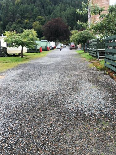 a gravel road with a person walking down the street at Swift Bordeaux Sea View 15 in Dunoon