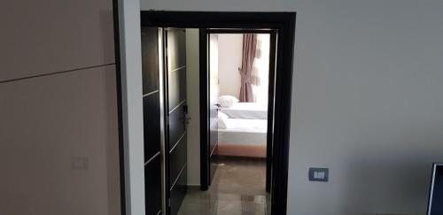 a room with a mirror and a bedroom with a bed at Villa Anastasia Ksamil in Ksamil