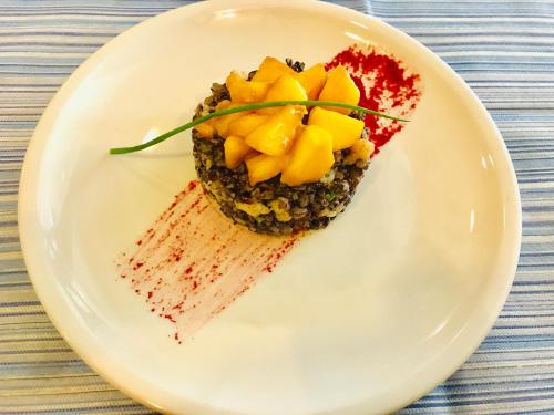 a white plate with a dessert on a table at Hotel Jole in San Mauro a Mare