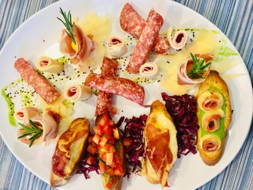 a plate of food with different types of food at Hotel Jole in San Mauro a Mare