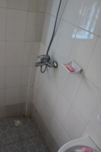a bathroom with a shower with a toilet at OCEAN-SI Mansion in Kribi