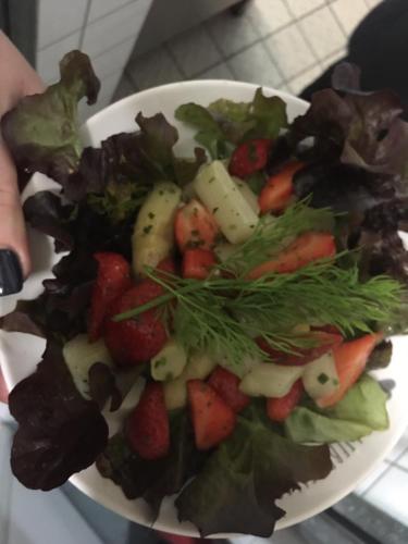 a bowl of salad with strawberries and other vegetables at Das Loreley Weinstuebchen in Sankt Goarshausen