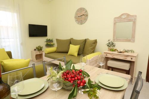 a dining room with a table and a couch at Elia in Skála Foúrkas