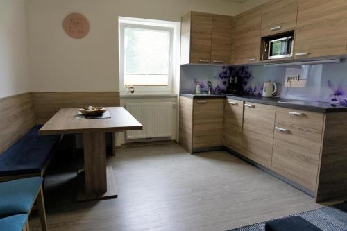 a small kitchen with a table and a window at Viktoria Apartments in Bled