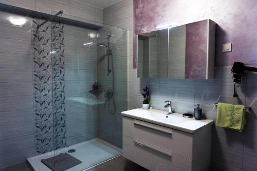 a bathroom with a sink and a shower at Viktoria Apartments in Bled