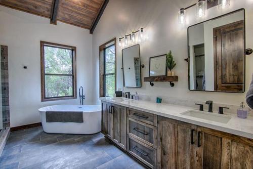a large bathroom with a tub and two sinks at The Cabin Home in Show Low