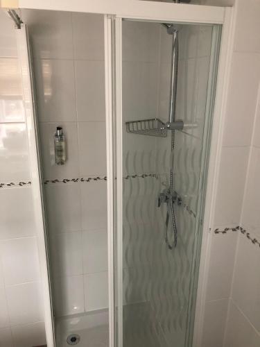 a shower with a glass door in a bathroom at The George at Nunney in Frome