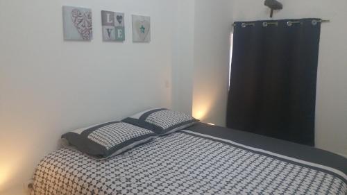 a bed with two pillows on it in a bedroom at Mistral in Saint-Jean-de-Fos