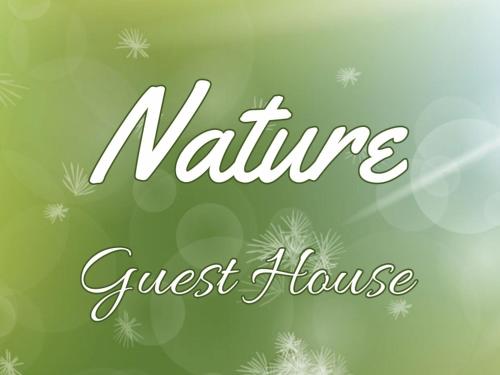 a sign that reads nine guest house guest house at Nature Guesthouse in Lagos