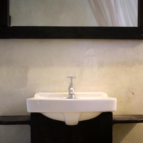 a white sink in a bathroom with a mirror at Coqui Coqui Papholchac Coba Residence & Spa in Cobá