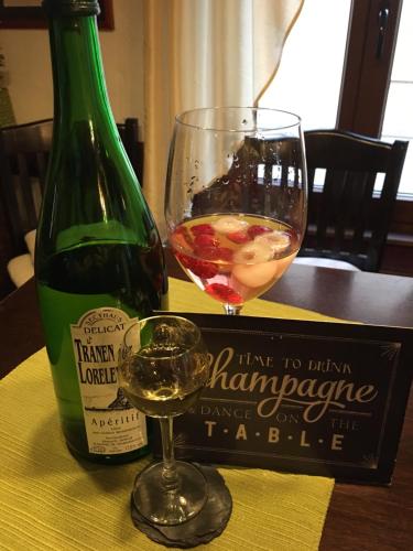 a bottle of wine and a glass on a table at Das Loreley Weinstuebchen in Sankt Goarshausen