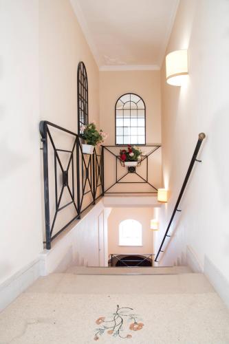 a hallway with stairs with a window and a flower pot at La Dolce Vista - B&B di Charme in Manfredonia