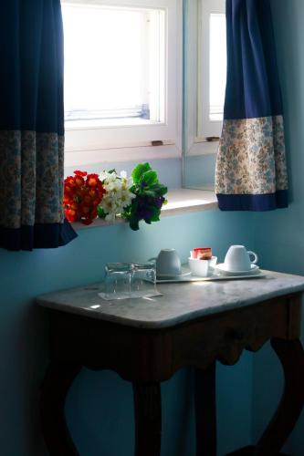 a table in a kitchen with a window and flowers at La Dolce Vista - B&B di Charme in Manfredonia