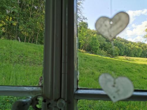 a window with two hearts on the glass at Ferienhof Ehlers in Hülsede