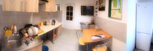 a small kitchen with a counter and a table at Kwatery w Gołdapi in Gołdap