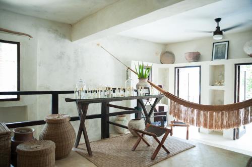 a living room with a table and a chair at Coqui Coqui Papholchac Coba Residence & Spa in Cobá