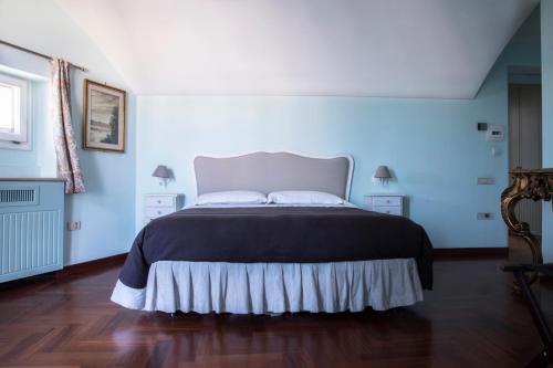 a bedroom with a large bed with a black blanket at La Dolce Vista - B&B di Charme in Manfredonia