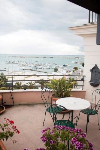 a balcony with a table and chairs and a view of the harbor at La Dolce Vista - B&B di Charme in Manfredonia