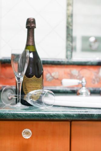 a bottle of wine and glasses on a counter at La Dolce Vista - B&B di Charme in Manfredonia