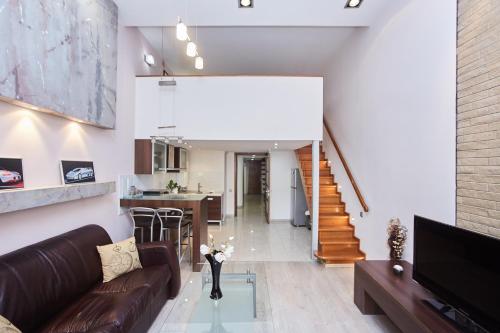a living room with a couch and a table at Langery Residence Central Apartments in Odesa