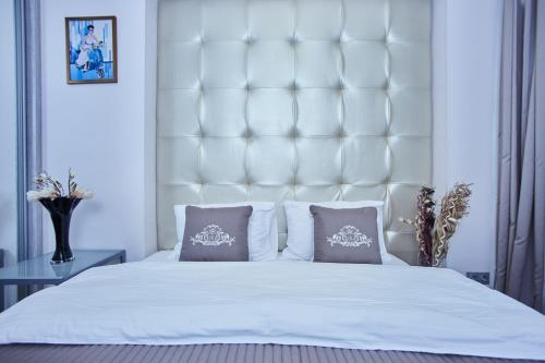 a bedroom with a large white bed with two pillows at Langery Residence Central Apartments in Odesa