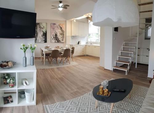 a living room with a dining table and a kitchen at Seaside Maisonette House in Artemida