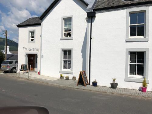 a white building with a sign in front of it at Swift Bordeaux Sea View 15 in Dunoon