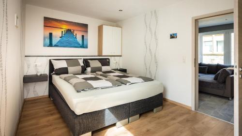 a bedroom with a large bed and a couch at FeWo-tt 2 in Traben-Trarbach