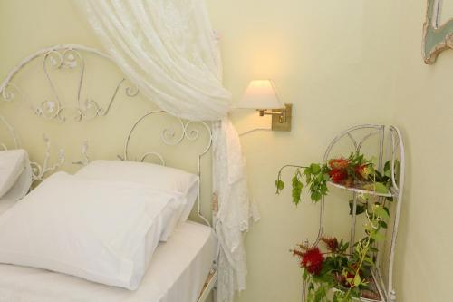 a bedroom with a white bed with a metal headboard at Elia in Skála Foúrkas