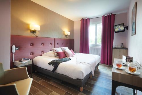 a bedroom with a large bed with red curtains at Pont du Chalon Hôtel and Restaurant in Margès