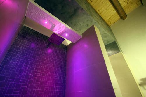 a purple shower with purple lights in a bathroom at Khalisah in Palermo